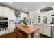 A modern kitchen features a wooden island, stainless steel appliances, and ample storage at 6935 York Pl, Cumming, GA 30040
