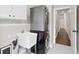 A laundry room features a sink, stacked washer and dryer, and access to hallway at 6935 York Pl, Cumming, GA 30040