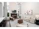 Cozy living room featuring a fireplace, modern lighting, and comfortable seating area at 6935 York Pl, Cumming, GA 30040