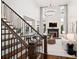 Inviting living room with modern staircase, fireplace, and tall windows for abundant natural light at 6935 York Pl, Cumming, GA 30040