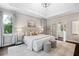 A serene bedroom with neutral tones, a plush bed, and bright, natural light at 6935 York Pl, Cumming, GA 30040