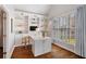 Well-lit home office with custom built-ins, desk, and large windows overlooking lush greenery at 6935 York Pl, Cumming, GA 30040