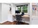 Well-lit office space featuring a modern desk, chair, and built-in shelves, perfect for remote work at 6935 York Pl, Cumming, GA 30040