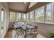 Relaxing screened porch with hanging swing, outdoor seating, and a view of the serene backyard at 6935 York Pl, Cumming, GA 30040