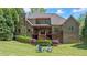 Lush backyard with a large grassy area, mature trees, and a private wooded setting at 931 Fairfield Dr, Marietta, GA 30068