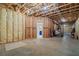 Spacious unfinished basement with insulated walls, exposed ceiling and doorway to finished part at 931 Fairfield Dr, Marietta, GA 30068