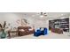 Basement featuring a comfortable seating area, a workspace with built-in bookshelves, and neutral carpet at 931 Fairfield Dr, Marietta, GA 30068