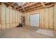 Unfinished basement featuring insulated walls, open ceiling, and access door for customization at 931 Fairfield Dr, Marietta, GA 30068