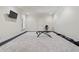 Basement workout area featuring an exercise bike, free weights, rubber flooring, and a wall-mounted television at 931 Fairfield Dr, Marietta, GA 30068