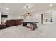 Finished basement with a pool table, sectional sofa, and kitchenette area with stainless-steel appliances at 931 Fairfield Dr, Marietta, GA 30068