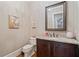 Stylish powder room with elegant vanity, granite countertop and decorative mirror at 931 Fairfield Dr, Marietta, GA 30068