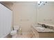 Bathroom with a tub-shower combo, neutral walls, granite vanity, and light tile floors at 931 Fairfield Dr, Marietta, GA 30068