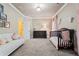 Elegant bedroom with crib, white settee with pink pillows and a dark wood dresser at 931 Fairfield Dr, Marietta, GA 30068