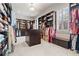 Spacious walk-in closet with custom shelving and storage, carpeted floor, and window at 931 Fairfield Dr, Marietta, GA 30068