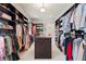 Large walk-in closet with custom storage and shelving, carpeted floor and central dresser at 931 Fairfield Dr, Marietta, GA 30068