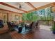 Spacious covered deck with ceiling fan, outdoor seating, and a wooded view at 931 Fairfield Dr, Marietta, GA 30068