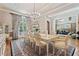 Formal dining room with chandelier, large window, hardwood floors, and elegant table setting at 931 Fairfield Dr, Marietta, GA 30068