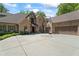 Lovely home with a circular driveway, mature landscaping, and a three-car garage at 931 Fairfield Dr, Marietta, GA 30068
