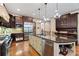 Gourmet kitchen with dark wood cabinets, stainless steel appliances, and granite countertops at 931 Fairfield Dr, Marietta, GA 30068