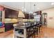 A gourmet kitchen with dark wood cabinets, granite countertops, a large island, and stainless steel appliances at 931 Fairfield Dr, Marietta, GA 30068