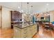 A kitchen island with granite countertops, custom cabinets, and stainless steel appliances at 931 Fairfield Dr, Marietta, GA 30068