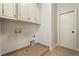 Functional laundry room featuring tile floor, cabinets and utility connections at 931 Fairfield Dr, Marietta, GA 30068