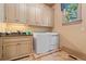 Bright laundry room with granite countertops, cabinetry, and a modern washer and dryer at 931 Fairfield Dr, Marietta, GA 30068