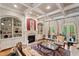 Living room with coffered ceilings, built-in bookshelves, fireplace, and elegant furniture at 931 Fairfield Dr, Marietta, GA 30068