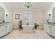 Luxurious bathroom with a freestanding tub, double vanities, and travertine flooring at 931 Fairfield Dr, Marietta, GA 30068