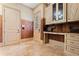 Spacious mud room boasts custom cabinetry, a built-in desk, and travertine flooring at 931 Fairfield Dr, Marietta, GA 30068