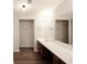 Bathroom featuring double sinks and wooden cabinets at 1905 Granville Dr, Lawrenceville, GA 30043