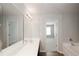 Bathroom featuring double sinks, tub, and standing shower at 1905 Granville Dr, Lawrenceville, GA 30043