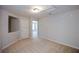 Carpeted bedroom with a light fixture and neutral paint. Doorway leads into another room at 1905 Granville Dr, Lawrenceville, GA 30043