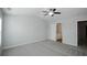 Light gray bedroom featuring a ceiling fan and carpet floors at 1905 Granville Dr, Lawrenceville, GA 30043