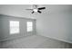 Bright bedroom featuring two windows and a ceiling fan at 1905 Granville Dr, Lawrenceville, GA 30043