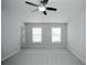Bright bedroom featuring two windows and a ceiling fan at 1905 Granville Dr, Lawrenceville, GA 30043