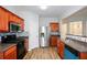 Kitchen featuring stainless steel refrigerator, sleek countertops, wooden cabinets, and hardwood floors at 1905 Granville Dr, Lawrenceville, GA 30043