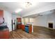Open kitchen with stainless steel refrigerator, tiled backsplash, and hardwood floors that flow into the living room at 1905 Granville Dr, Lawrenceville, GA 30043