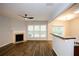 Bright living room features a modern ceiling fan, fireplace, and wood-look flooring at 1905 Granville Dr, Lawrenceville, GA 30043