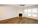 Light-filled living room with wood floors, fireplace, and large windows at 1905 Granville Dr, Lawrenceville, GA 30043