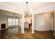Open floor plan showcasing living room, kitchen, and dining area with modern light fixture at 1905 Granville Dr, Lawrenceville, GA 30043