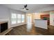 Bright living area with wood floors, a fireplace, and a view to the kitchen at 1905 Granville Dr, Lawrenceville, GA 30043