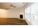 Well-lit living area featuring a fireplace, wood floors, and large windows at 1905 Granville Dr, Lawrenceville, GA 30043