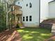 A backyard with a tiered wooden deck and a retaining wall for landscaping at 30 Riverrock Trl, Dallas, GA 30157