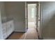 Bathroom leading into the bedroom that features white cabinets, a quartz countertop, and tiled shower at 30 Riverrock Trl, Dallas, GA 30157