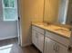 Bathroom vanity features double sinks with a window providing natural light at 30 Riverrock Trl, Dallas, GA 30157