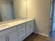 Bathroom features a double sink vanity with quartz countertops and white cabinets at 30 Riverrock Trl, Dallas, GA 30157