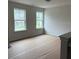 Bright, unfurnished room with windows overlooking the front yard, providing ample natural light at 30 Riverrock Trl, Dallas, GA 30157