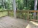 Wooden deck with railings offering a view of the surrounding greenery at 30 Riverrock Trl, Dallas, GA 30157