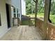 Wooden deck with railings offering a view of the backyard and surrounding greenery at 30 Riverrock Trl, Dallas, GA 30157